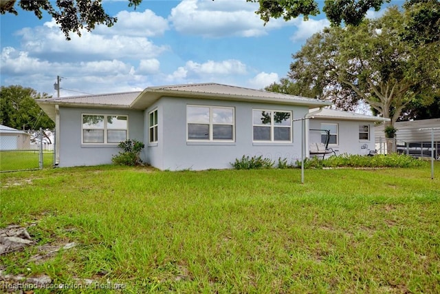 rear view of property with a yard