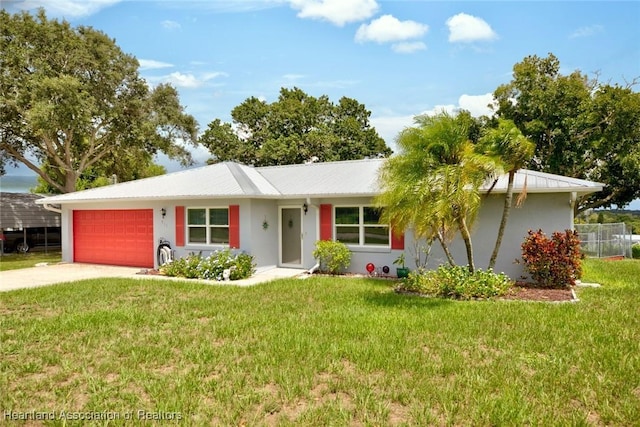 ranch-style home with a front yard and a garage