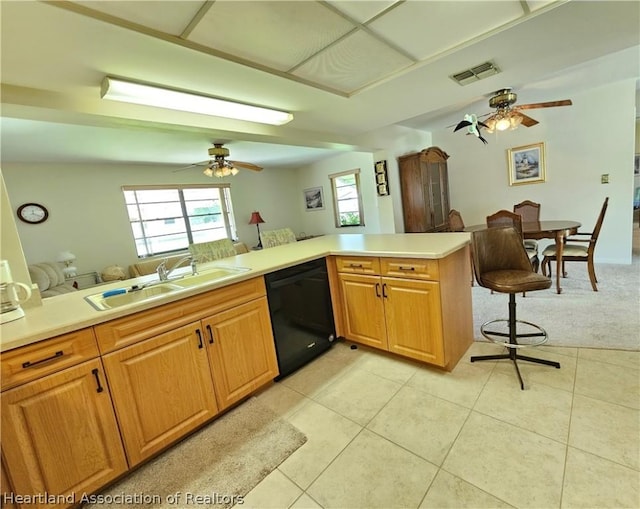 kitchen with kitchen peninsula, ceiling fan, sink, black dishwasher, and light tile patterned flooring