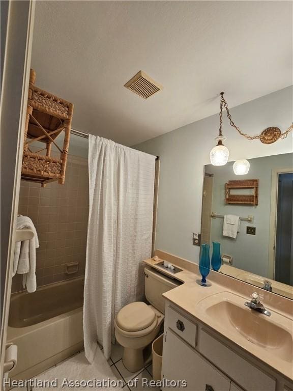 full bathroom with tile patterned floors, vanity, shower / tub combo, and toilet