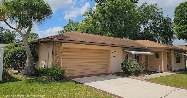 view of front of home with a garage and a front yard