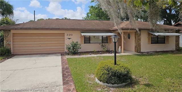 single story home featuring a front yard and a garage