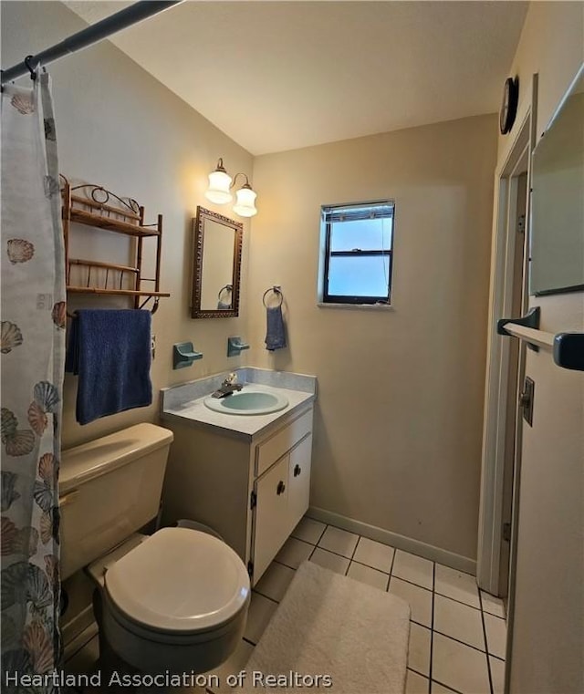 bathroom featuring tile patterned floors, vanity, and toilet