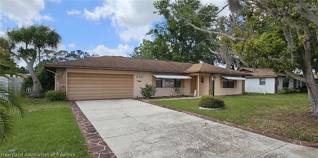 single story home featuring a garage and a front yard