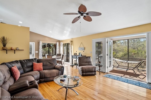 living room featuring lofted ceiling, a ceiling fan, wood finished floors, and recessed lighting