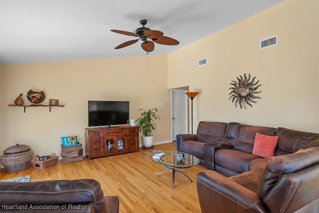 living area featuring a ceiling fan, baseboards, visible vents, and wood finished floors