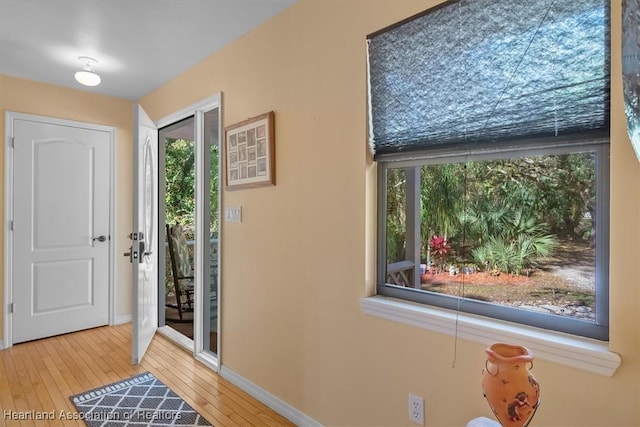 entryway featuring hardwood / wood-style floors and baseboards