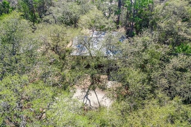 birds eye view of property featuring a wooded view