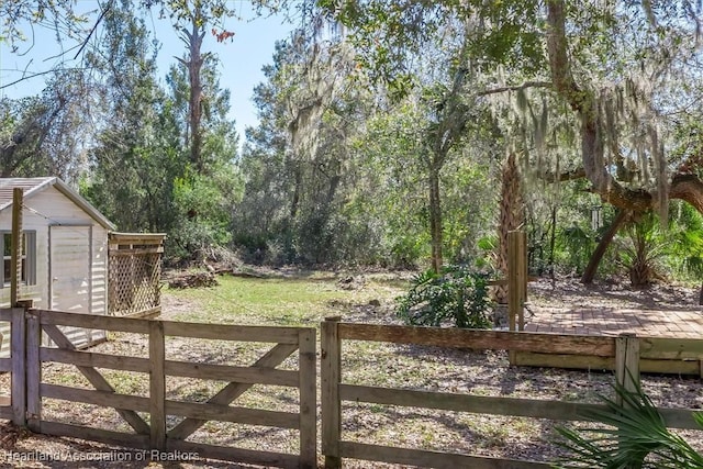 view of gate with fence and a wooden deck