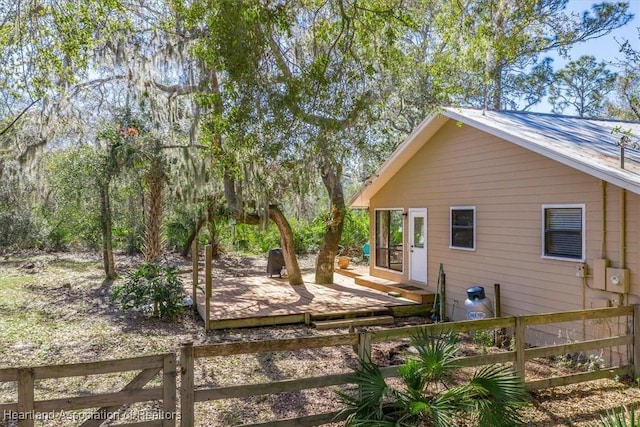 view of yard featuring fence and a wooden deck