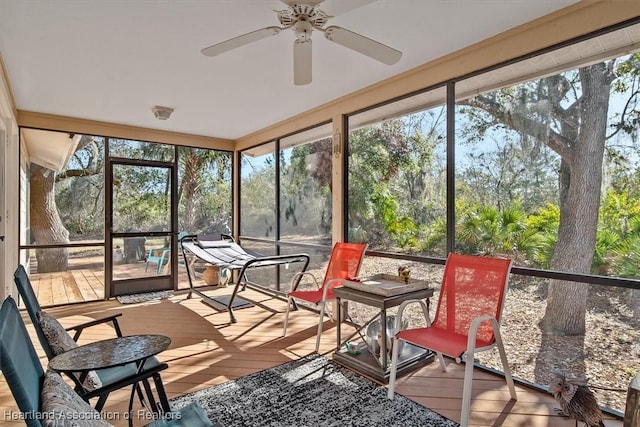 sunroom / solarium featuring ceiling fan