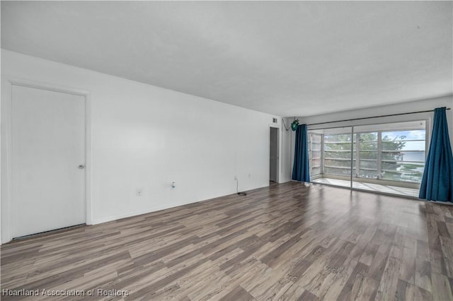 spare room featuring hardwood / wood-style flooring