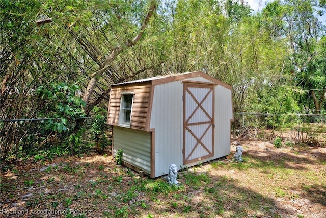 view of shed with fence
