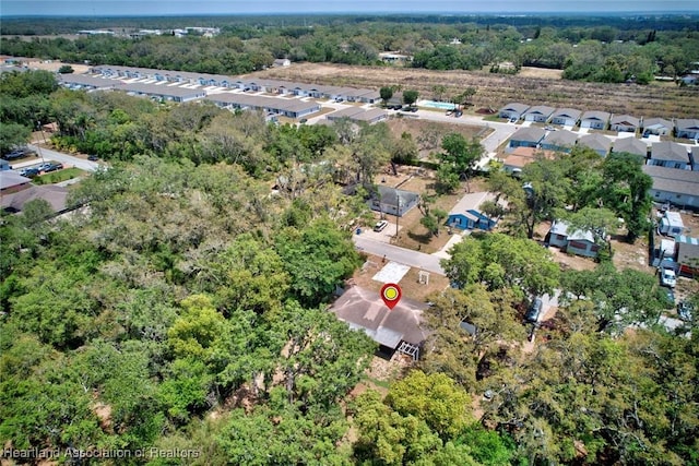 birds eye view of property featuring a residential view and a forest view