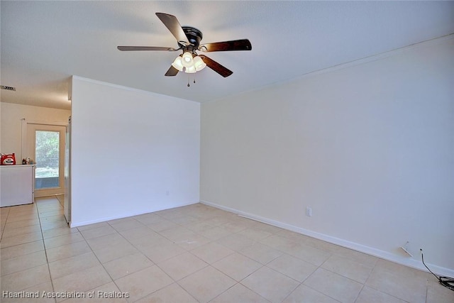 unfurnished room with light tile patterned flooring, ceiling fan, ornamental molding, and baseboards
