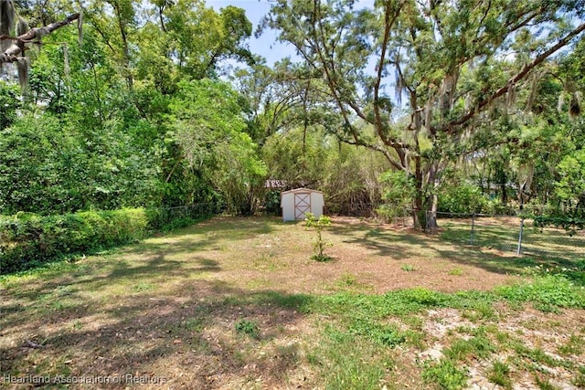 view of yard with a storage shed, an outdoor structure, and a fenced backyard