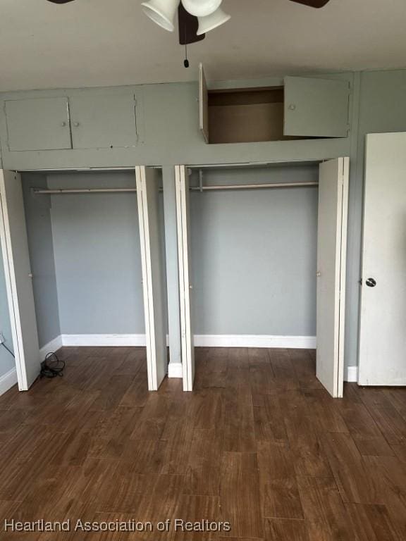 unfurnished bedroom featuring ceiling fan and dark wood-type flooring