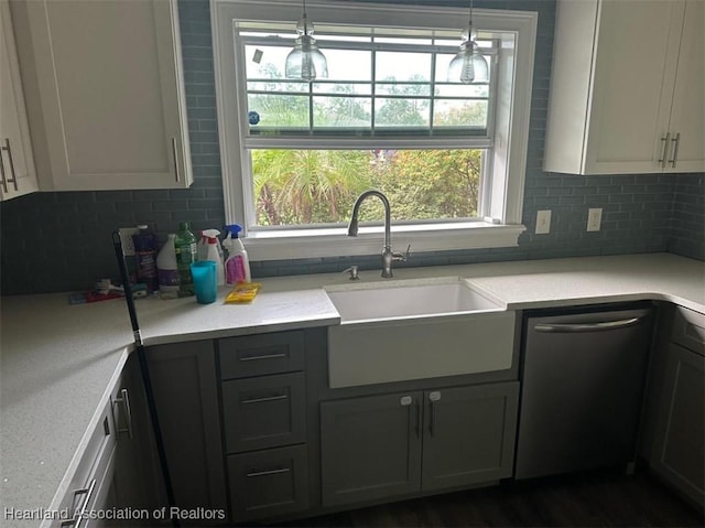 kitchen with backsplash, gray cabinetry, sink, pendant lighting, and dishwasher