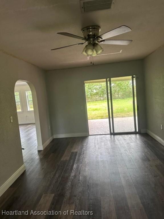 empty room featuring ceiling fan and dark hardwood / wood-style floors