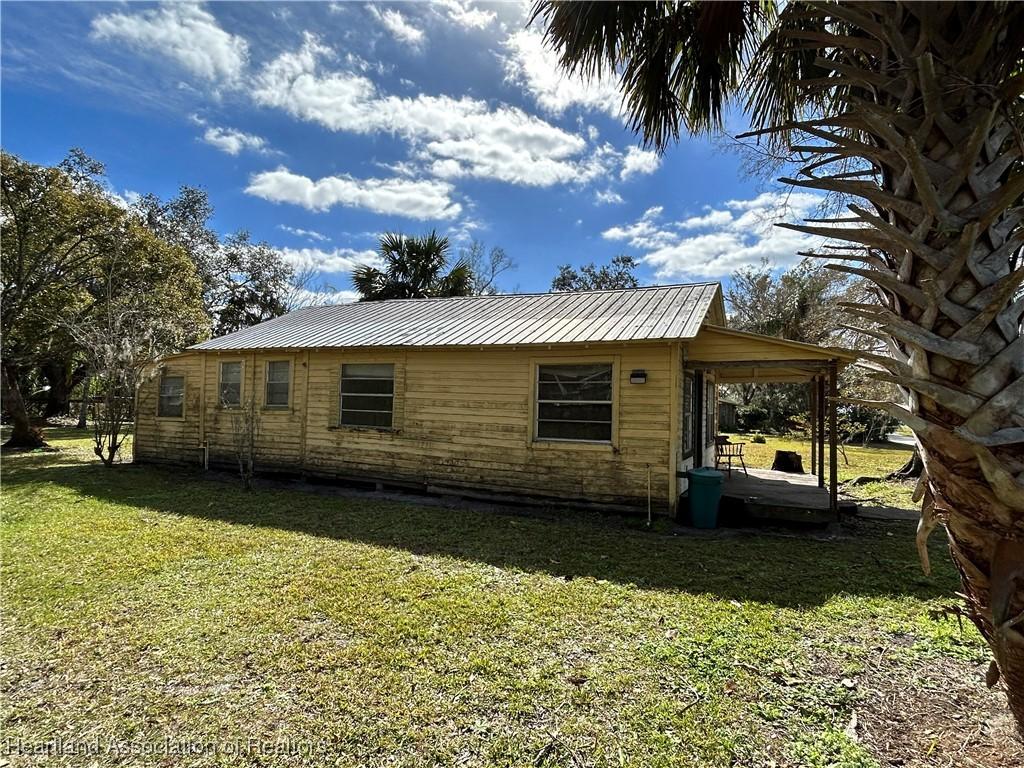 view of side of property with a lawn