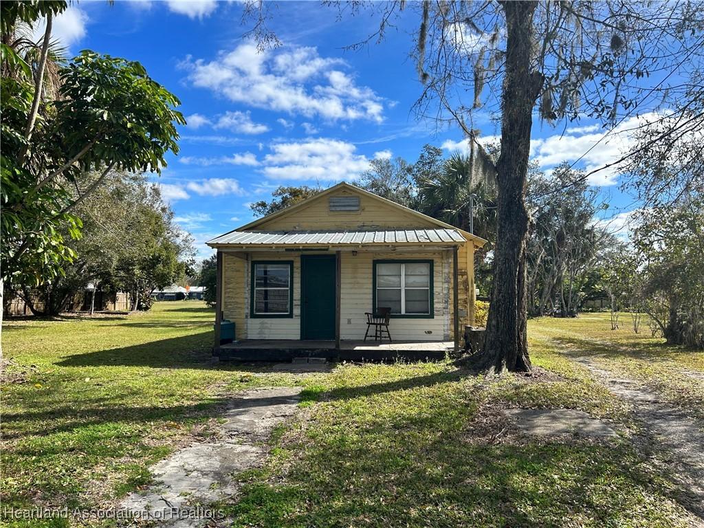 bungalow-style home with a front lawn