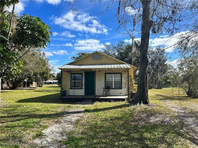 bungalow-style home with a front lawn