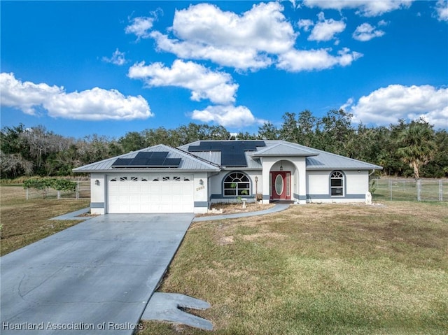 single story home with a garage, a front yard, and solar panels