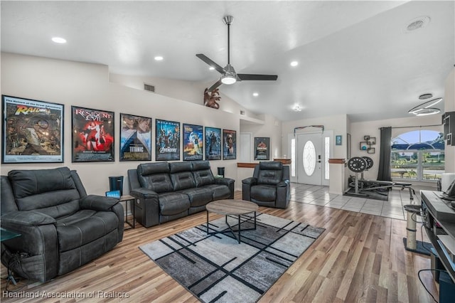 living room featuring ceiling fan, high vaulted ceiling, and light hardwood / wood-style flooring