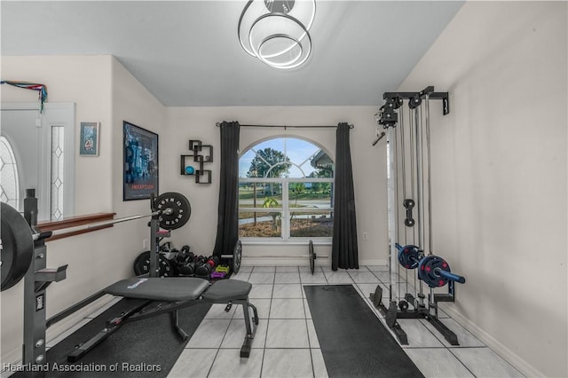 exercise room with light tile patterned floors