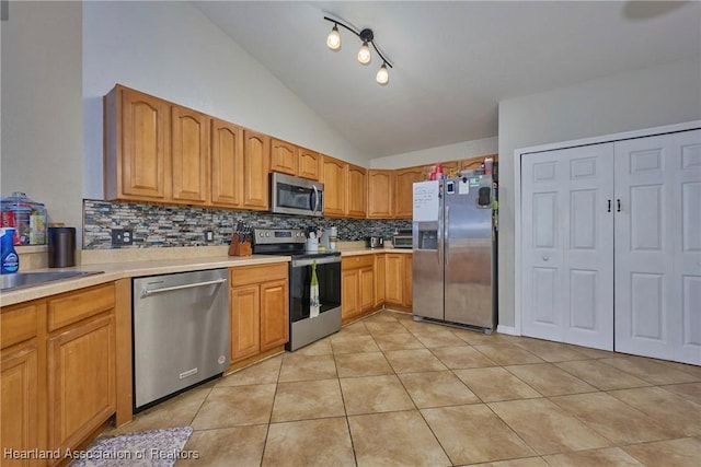 4703 Benton St, Lake Wales, FL 33859 - kitchen featuring stainless steel appliances, lofted ceiling, backsplash, light tile patterned flooring, and light countertops