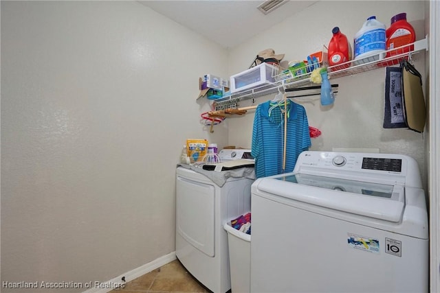 4703 Benton St, Lake Wales, FL 33859 - laundry area with washer and dryer, light tile patterned floors, and baseboards