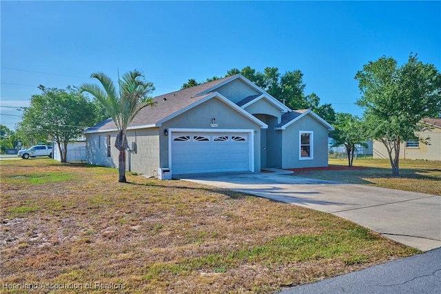4703 Benton St, Lake Wales, FL 33859 - ranch-style house with an attached garage, driveway, a front lawn, and stucco siding
