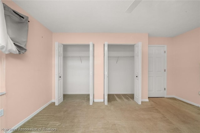 5808 Twisted Oaks Dr, Sebring, FL 33876 - unfurnished bedroom with two closets, carpet floors, baseboards, and a ceiling fan
