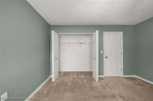5808 Twisted Oaks Dr, Sebring, FL 33876 - unfurnished bedroom with carpet flooring, a closet, baseboards, and a textured ceiling