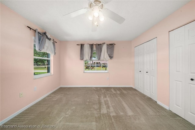 5808 Twisted Oaks Dr, Sebring, FL 33876 - unfurnished bedroom featuring carpet floors, multiple closets, baseboards, and ceiling fan