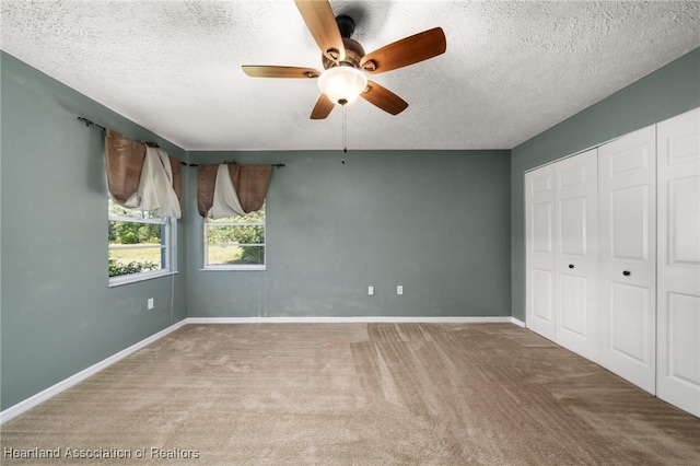 5808 Twisted Oaks Dr, Sebring, FL 33876 - unfurnished bedroom featuring carpet, a textured ceiling, baseboards, a closet, and ceiling fan