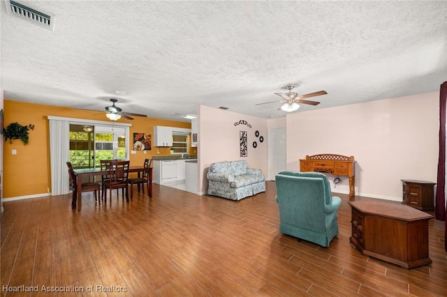 5808 Twisted Oaks Dr, Sebring, FL 33876 - living room with a ceiling fan, wood finished floors, a textured ceiling, and baseboards