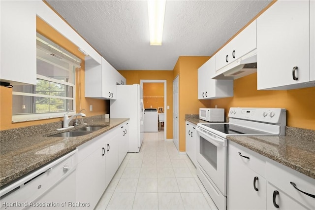 5808 Twisted Oaks Dr, Sebring, FL 33876 - kitchen with white appliances, a sink, under cabinet range hood, washer and dryer, and white cabinetry