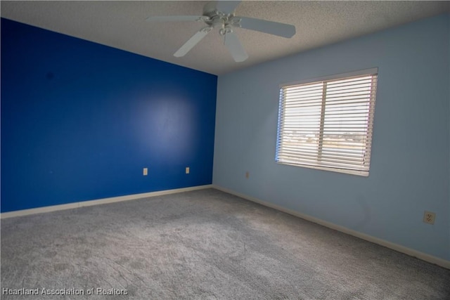 bedroom featuring carpet, a textured ceiling, a walk in closet, a closet, and ceiling fan