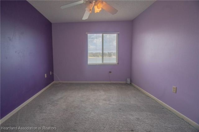 carpeted spare room with ceiling fan and a textured ceiling