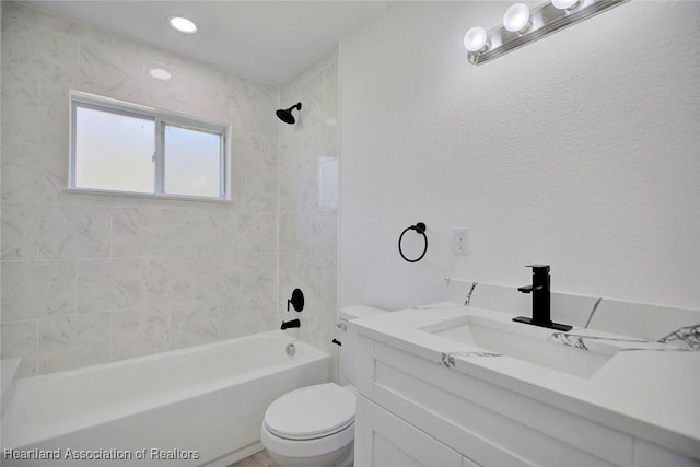 full bathroom with vanity, toilet, and tiled shower / bath