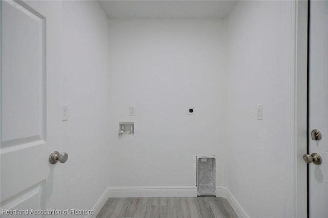 clothes washing area featuring hookup for an electric dryer, hookup for a washing machine, and light hardwood / wood-style flooring