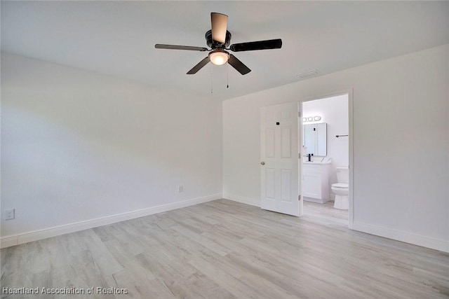 unfurnished bedroom with light wood-type flooring, ensuite bathroom, and ceiling fan