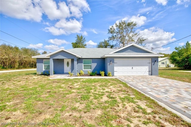 single story home featuring a garage and a front lawn