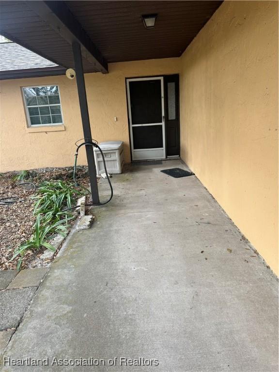 doorway to property with a patio