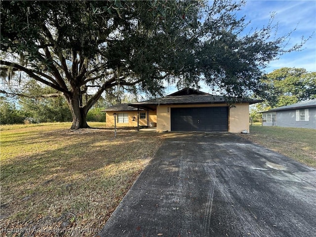 single story home with a garage and a front lawn