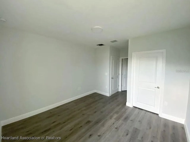 spare room with hardwood / wood-style floors