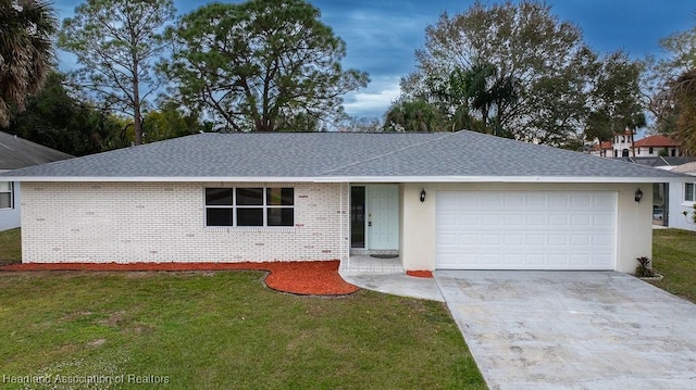 single story home featuring a garage and a front lawn