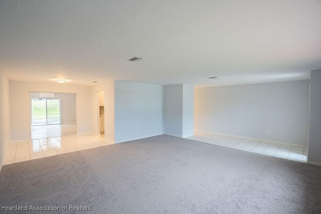 unfurnished room featuring light carpet