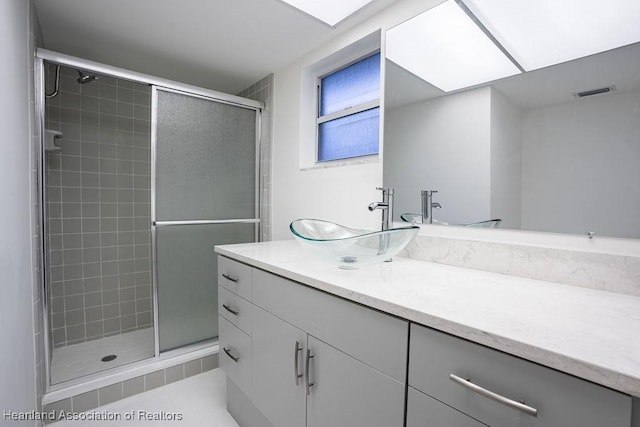 bathroom featuring walk in shower and vanity